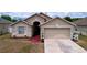 Charming single-Gathering home with a two-car garage, manicured lawn, and tasteful landscaping at 24305 Denali Ct, Lutz, FL 33559