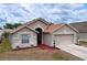 Charming single-Gathering home featuring a well-maintained lawn and a two-car garage at 24305 Denali Ct, Lutz, FL 33559