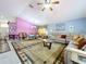 Inviting living room featuring comfortable seating, a ceiling fan, and plenty of natural light at 24305 Denali Ct, Lutz, FL 33559