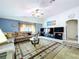 Spacious living room with plush seating, ceiling fan, and ample natural light for relaxing at 24305 Denali Ct, Lutz, FL 33559