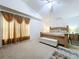 Spacious main bedroom with a large window, neutral decor, and a ceiling fan at 24305 Denali Ct, Lutz, FL 33559