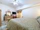 The main bedroom includes a ceiling fan, large window, and neutral decor at 24305 Denali Ct, Lutz, FL 33559