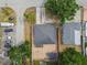 Overhead view of a single Gathering home featuring a gray roof, brick patio, and lush greenery surrounding the home at 2701 W Osborne Ave, Tampa, FL 33614