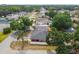 A residential property surrounded by mature trees, featuring a cozy backyard and white fenced perimeter at 2701 W Osborne Ave, Tampa, FL 33614