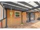 Backyard featuring a covered patio with a pergola, brick pavers, and landscaped areas at 2701 W Osborne Ave, Tampa, FL 33614