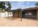 Spacious brick patio with a covered lounge area and lush landscaping at 2701 W Osborne Ave, Tampa, FL 33614