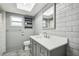 Bathroom features vanity with marble countertop and gray subway tile at 2701 W Osborne Ave, Tampa, FL 33614