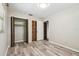Bright bedroom features gray wood-look floors, window, and two closets at 2701 W Osborne Ave, Tampa, FL 33614