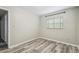 Bright bedroom features gray wood-look floors and a window at 2701 W Osborne Ave, Tampa, FL 33614
