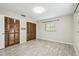 Bright bedroom features gray wood-look floors, window, two closets with paneled doors at 2701 W Osborne Ave, Tampa, FL 33614
