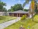 Charming home with a well-manicured lawn, fenced yard, and ample driveway space for convenient parking at 2701 W Osborne Ave, Tampa, FL 33614