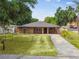 Charming single-story home with a well-manicured lawn and a classic front porch at 2701 W Osborne Ave, Tampa, FL 33614