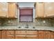 Close-up of the kitchen sink and granite countertops with a window view at 2701 W Osborne Ave, Tampa, FL 33614