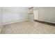 Inviting room featuring tile flooring, white door, and wooden accent beams at 2701 W Osborne Ave, Tampa, FL 33614