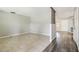 Spacious living room with tile flooring, wood detailing, neutral wall colors, and open access to hallway at 2701 W Osborne Ave, Tampa, FL 33614
