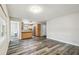 Open floor plan features plank flooring and adjacent kitchen space at 2701 W Osborne Ave, Tampa, FL 33614