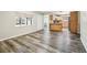 Large room features plank floors, window and opening to view kitchen at 2701 W Osborne Ave, Tampa, FL 33614