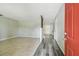 Open-concept living room featuring tile flooring, wood accents, fresh paint, and seamless transition to other rooms at 2701 W Osborne Ave, Tampa, FL 33614
