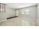Spacious living room with tile flooring, front door, and bright window at 2701 W Osborne Ave, Tampa, FL 33614