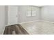 Bright living room with tile flooring, white front door and window with mini blinds at 2701 W Osborne Ave, Tampa, FL 33614