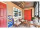Enclosed porch with brick pavers, ceiling fan, seating area and colorful decorations at 2701 W Osborne Ave, Tampa, FL 33614