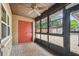 Enclosed porch with brick pavers, ceiling fan, and views to the fenced backyard at 2701 W Osborne Ave, Tampa, FL 33614