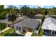 Aerial view of a charming gray home with a well-manicured lawn and a wooden-paneled garage door at 2906 E Columbus Dr, Tampa, FL 33605