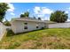 Spacious backyard with lush green lawn and a modern, gray house exterior at 2906 E Columbus Dr, Tampa, FL 33605