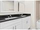 Bathroom with double sinks and granite countertops and a tiled shower and tub at 2906 E Columbus Dr, Tampa, FL 33605