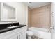 Well-lit bathroom with granite countertops and a tiled shower and bath combination at 2906 E Columbus Dr, Tampa, FL 33605