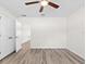 A simple bedroom design is accented with a ceiling fan, closet, and wood look flooring at 2906 E Columbus Dr, Tampa, FL 33605