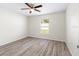 Bright bedroom features natural light and includes ceiling fan and wood look flooring at 2906 E Columbus Dr, Tampa, FL 33605
