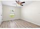 Bright bedroom with a window overlooking the yard and nice wood look flooring at 2906 E Columbus Dr, Tampa, FL 33605