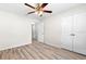 A bedroom featuring wood look floors, a ceiling fan, and a double door closet at 2906 E Columbus Dr, Tampa, FL 33605