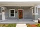 Welcoming front porch with updated features, fresh paint, and a new front door at 2906 E Columbus Dr, Tampa, FL 33605