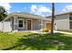 Inviting single-story home with a beautiful lawn and a charming front entrance at 2906 E Columbus Dr, Tampa, FL 33605