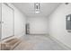 Spacious garage interior with concrete flooring, water heater, neutral paint, and overhead lighting at 2906 E Columbus Dr, Tampa, FL 33605