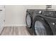 Modern laundry room with updated Samsung washer and dryer and wood look floors at 2906 E Columbus Dr, Tampa, FL 33605