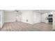 Open living space with neutral walls, modern flooring, and an adjacent kitchen area at 2906 E Columbus Dr, Tampa, FL 33605