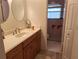 Bathroom featuring a single sink vanity with wood cabinets and a step-in shower at 2910 Star Apple Ct, Palm Harbor, FL 34684