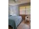 Light and airy bedroom featuring tile floors, ceiling fan, and sunny windows with vertical blinds at 2910 Star Apple Ct, Palm Harbor, FL 34684