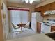 Eat-in kitchen with a window, white appliances and breakfast table at 2910 Star Apple Ct, Palm Harbor, FL 34684