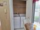 Convenient laundry closet featuring a side-by-side washer and dryer at 2910 Star Apple Ct, Palm Harbor, FL 34684
