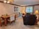Cozy living room with a combination of carpet and tile and comfortable seating arrangements at 2910 Star Apple Ct, Palm Harbor, FL 34684