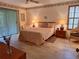 Serene main bedroom with tile floors, a ceiling fan, and windows for natural light at 2910 Star Apple Ct, Palm Harbor, FL 34684