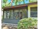 Enclosed and screened patio with view of the lush backyard at 2910 Star Apple Ct, Palm Harbor, FL 34684
