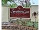 Entrance sign for Strathmore Gate East, a deed-restricted community, surrounded by lush landscaping at 2910 Star Apple Ct, Palm Harbor, FL 34684
