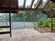 A shared tennis court and basketball court can be viewed from the covered patio and walkway at 2910 Star Apple Ct, Palm Harbor, FL 34684
