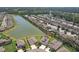 Expansive community with a picturesque lake, surrounded by well-maintained homes and landscaping at 30214 Skylark Dr, Wesley Chapel, FL 33545