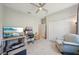Bedroom with tile floors, ceiling fan, and walk-in closet at 30214 Skylark Dr, Wesley Chapel, FL 33545